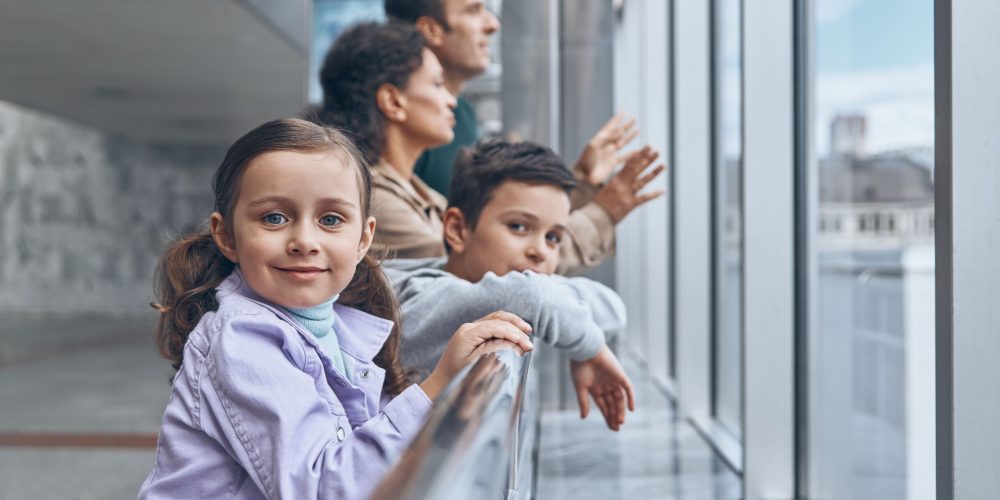 family-with-two-little-kids-waiting-for-their-flig-2023-11-27-04-56-09-utc-1-1